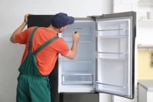 Technician repairing fridge in Boksburg for AR Appliance Repair